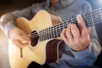 Fototapeta na wymiar Guitarist playing an acoustic classical guitar