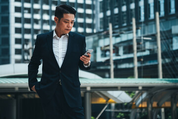 Business man using phone outside stock photo