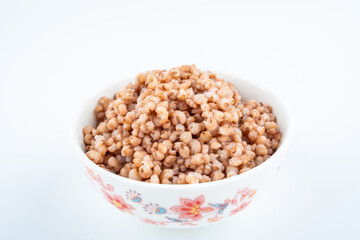 Fototapeta na wymiar Sorghum rice in a bowl on white background