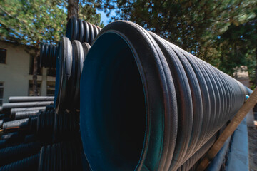 Corrugated water pipes of large diameter prepared for laying, copy space
