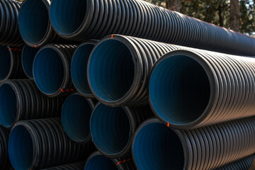 Corrugated water pipes of large diameter prepared for laying, copy space