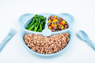 Nutritional meal for children on a plate on white background