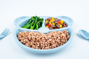 Nutritional meal for children on a plate on white background