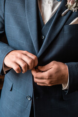 Groom button blue tuxedo close up. Wedding day concept. Wedding style.