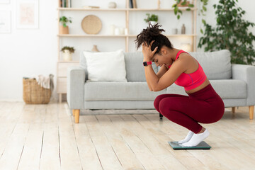 Desperate African Girl Shouting Standing On Weight-Scales At Home