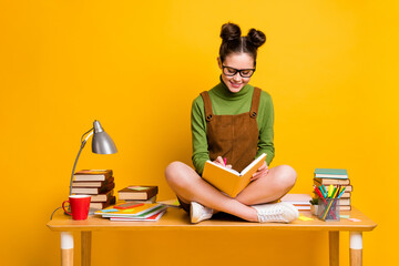 Full body photo of focused girl sit table legs crossed folded write copybook test exam project wear...