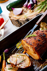Lecere roll roast with vegetables and herbs.