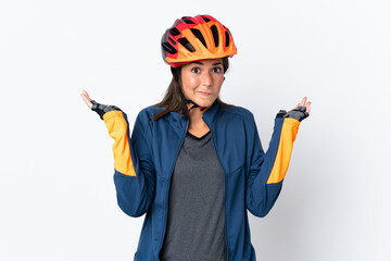 Young cyclist brazilian girl isolated on white  background having doubts while raising hands