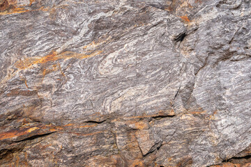 Rusted granite texture. Rusted stone background. Granite rocks. Colorful Rock background. Old Cracked Rusty Rough texture. Grunge Abstract Stone Surface.