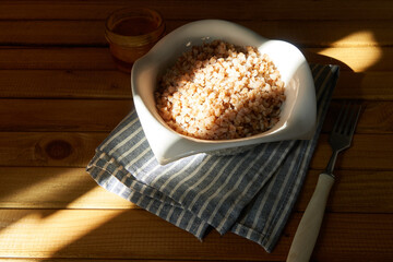 Boiled buckwheat porridge with butter served in a plate