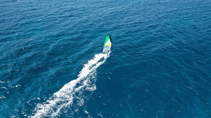 Obraz premium Aerial drone photo of wind surfer in open ocean deep blue sea on a windy morning