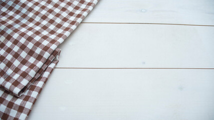 Wooden table covered with tablecloth cloth checkered