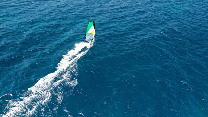 Obraz premium Aerial drone photo of wind surfer in open ocean deep blue sea on a windy morning