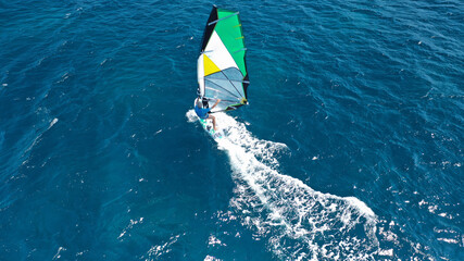 Aerial drone photo of wind surfer in open ocean deep blue sea on a windy morning