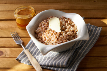 Boiled buckwheat porridge with butter served in a plate