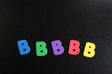 Random B Colorful Foam words on black board children kids background