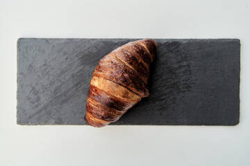 Croissant on a black tray top view. High-quality photo