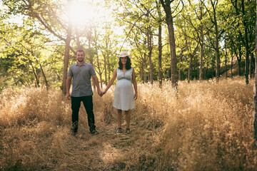 Couple in nature. Pregnant woman and bearded man.