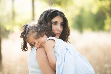 Naklejka premium Woman with daughter in outdoors image. Sad daughter