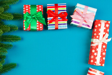 Top view of colorful holiday background made of fir tree and gift box. Happy New Year concept with copy space