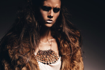 sexy aggressive woman in brown fur coat