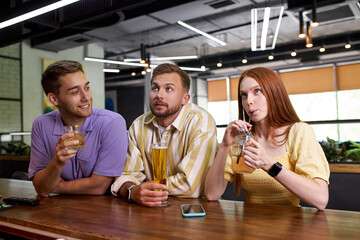 two male friends meet beautiful girl in bar, they have talk and some flirt. holidays, vacation, weekend concept