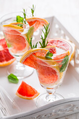Refreshing infused water with pink grapefruit, cantaloupe melon and mint