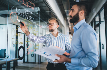 Smart casual men colleagues having productive cooperation on job share ideas during productive...