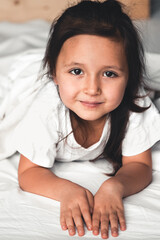 Adorable little girl awaked up in her bed