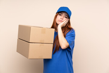 Young teenager delivery girl over isolated background unhappy and frustrated