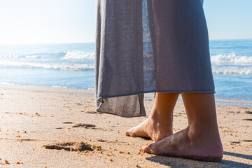 Beach travel - woman walking on sand beach closeup