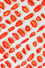 Homemade sun-Dried tomatoes on a light background. pattern, top View. Print for kitchen