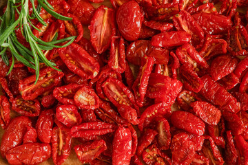 Homemade sun-Dried tomatoes with fresh rosemary. The view from the top. Print for kitchen