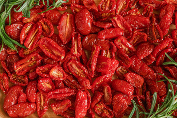Homemade sun-Dried tomatoes with fresh rosemary. The view from the top. Print for kitchen
