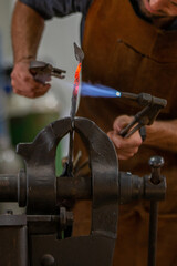 A blacksmith work on metal