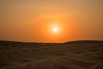 View of windy sand dunes deep in desert of Abu Dhabi - United Arab Emirates. Windy day in desert, desert safari.
