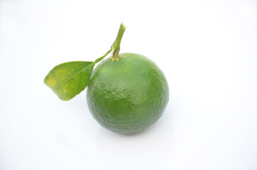 the ripe green orange fruit with leaves isolated on white background.