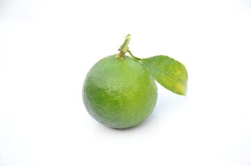 the ripe green orange fruit with leaves isolated on white background.