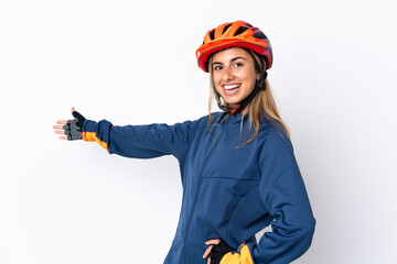 Young hispanic cyclist woman isolated on white background extending hands to the side for inviting to come