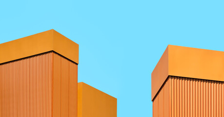 orange wall of a modern building against a blue sky
