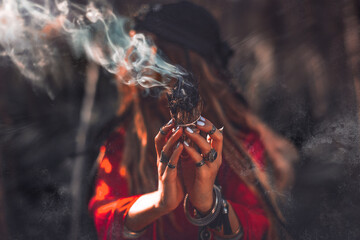 close up of woman hands with shamanic fire outdoors