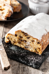 Christmas stollen fruit cake on wooden table. 	