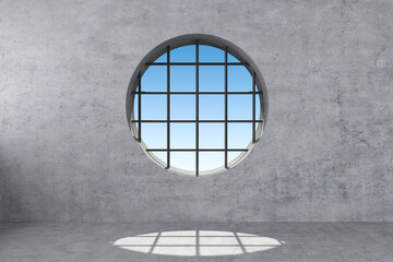 round window with grating in concrete wall