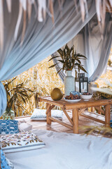 still life summer garden pavilion with blue designer pillows