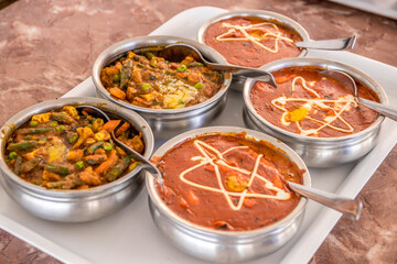 veg kadai and paneer butter masala curry being served in indian restaurant
