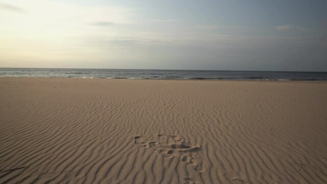 Meditative observation of the surf on a sandy Baltic beach. In September, the sea of the Gulf of Riga is deserted. The season is over. Latvia