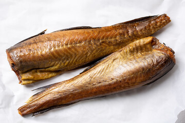 Two hot smoked pollock fish on white background. Top view.