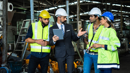 Industrial engineer and businessman in suite and safety helmet working in factory, planning,...