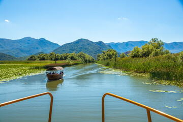 Landscape of a green river along with sailing fishing boats, nature of the national park