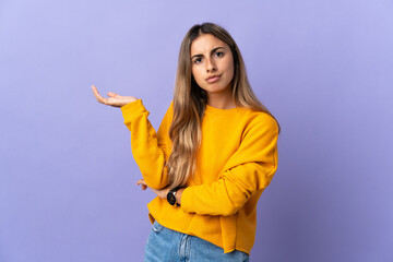 Young hispanic woman over isolated purple background having doubts